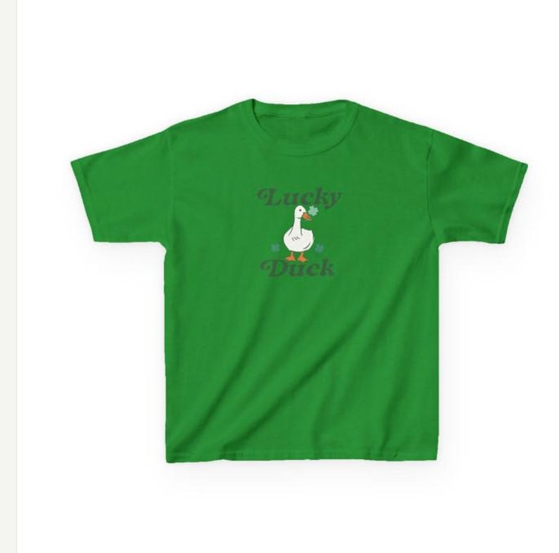 May include: A green t-shirt with a white duck wearing a shamrock. The text "Lucky Duck" is printed on the shirt.