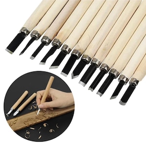 May include: A set of twelve wood carving tools with light-colored wooden handles and metal ferrules, each featuring a distinct steel blade shape. The collection includes various gouges, chisels, and v-tools for detailed woodworking projects.