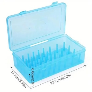 May include: A translucent blue plastic storage box with a hinged lid. The box is rectangular, measuring 23.7cm long, 13.7cm wide, and 6.6cm deep. Inside, there are numerous small, vertical pegs. The box is designed for organizing small items.