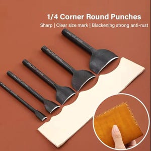 May include: A collection of black metal 1/4 corner round punches with curved blades, presented on a brown surface. The tools have size markings. A piece of light-coloured leather is cut with the punches, and a leather wallet is shown.
