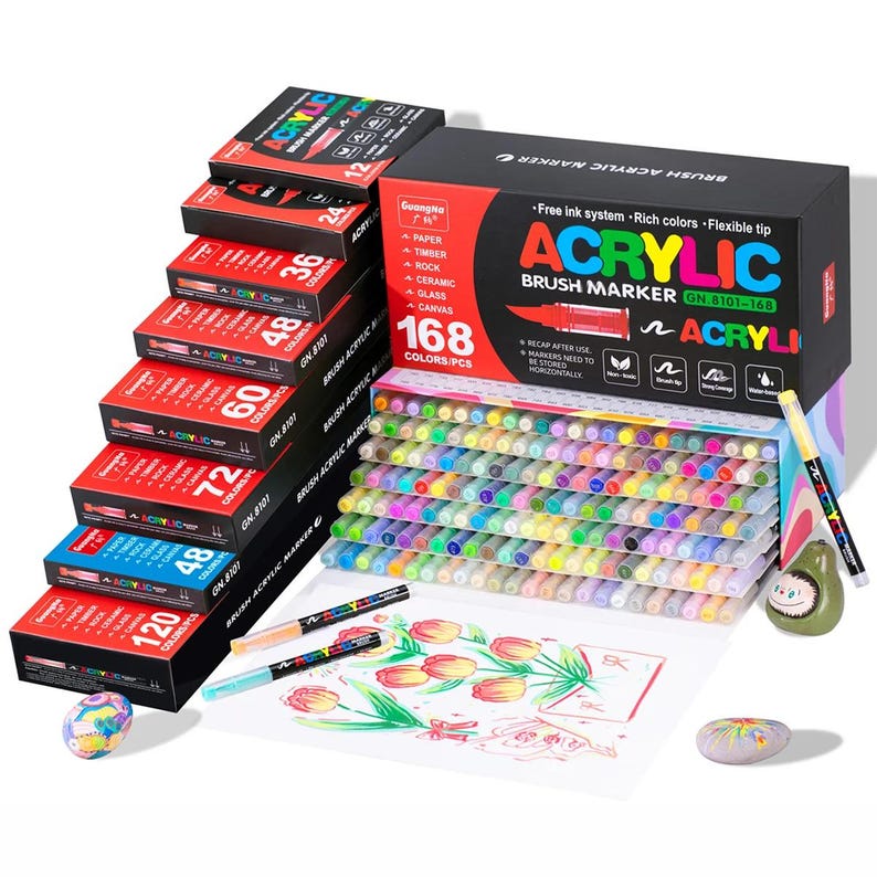 May include: A collection of acrylic brush markers in various colors, with boxes displaying the number of markers per box. The main box reads "ACRYLIC BRUSH MARKER" and "168 COLORS/PCS". The markers are suitable for paper, timber, rock, ceramic, glass, and canvas.