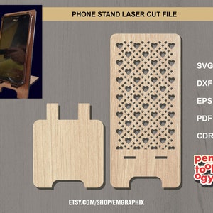 May include: Laser cut file for a phone stand with a heart pattern. The stand is made of wood and has a cutout design. The file is available in SVG, DXF, EPS, PDF, and CDR formats.