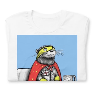 May include: A white t-shirt with a blue background featuring a cartoon otter wearing a red cape and yellow mask. The otter has a name tag that says "Steve". The otter is holding a coffee mug with a heart on it.