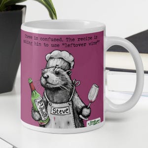 May include: White ceramic mug with a cartoon otter chef holding a wine bottle and a wine glass. The mug has the text "Steve is confused. The recipe is asking him to use "leftover wine"?" and "Steve" on the apron.