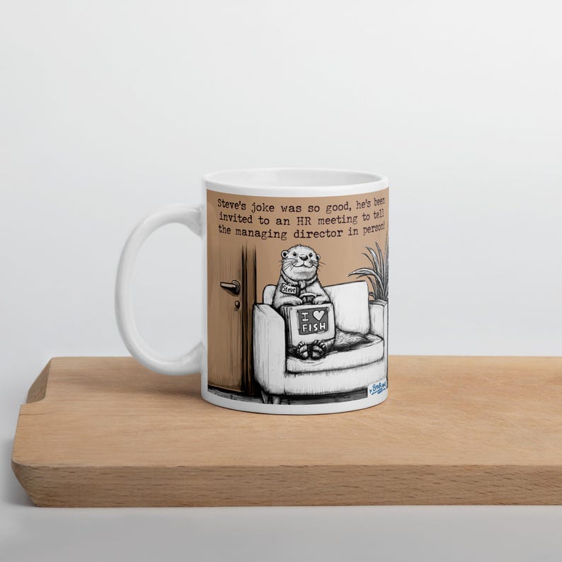 May include: White ceramic mug with a humorous cartoon illustration. The image features an otter sitting on a couch, holding a sign that says "I love fish." Text on the mug reads, "Steve's joke was so good, he's been invited to an HR meeting..."