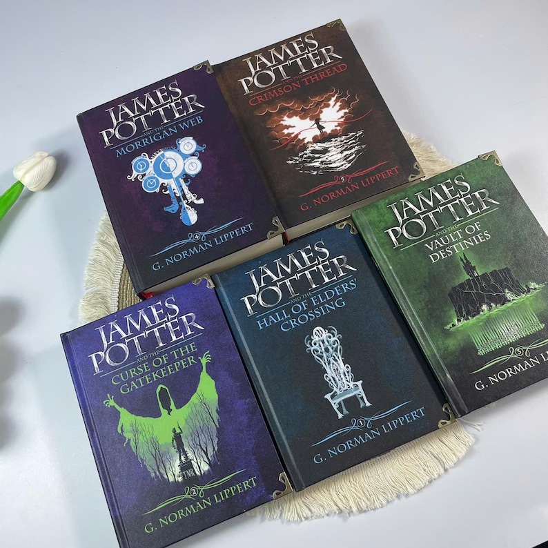 May include: A collection of five hardcover books titled "James Potter" with various subtitles. The book covers feature illustrations in shades of blue, green, and brown, with titles like "Morrigan Web" and "Crimson Thread".