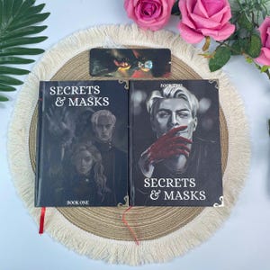 May include: A set of three ceramic mugs with a speckled, matte finish in cream, light grey, and dark grey. Each mug features a simple, minimalist design, ideal for tea or coffee.