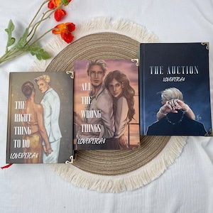 May include: Three hardcover books with illustrated covers. The titles are "The Right Thing To Do", "All The Wrong Things", and "The Auction". Each book features a different romantic illustration and the author's name, LOVERITCA8.
