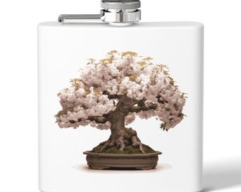 Peut inclure: Une gourde en acier inoxydable blanche avec un bouchon argenté et un motif d'arbre bonsaï avec des fleurs blanches dans un pot brun.