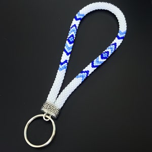 May include: White beaded key chain with a blue and white geometric pattern and a silver ring.  PDF Pattern.