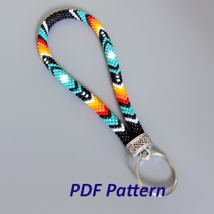 May include: A colorful beaded key chain with a silver key ring. The beads are black, white, turquoise, orange, and red. The key chain is made with a peyote stitch. The image includes the text "PDF Pattern".
