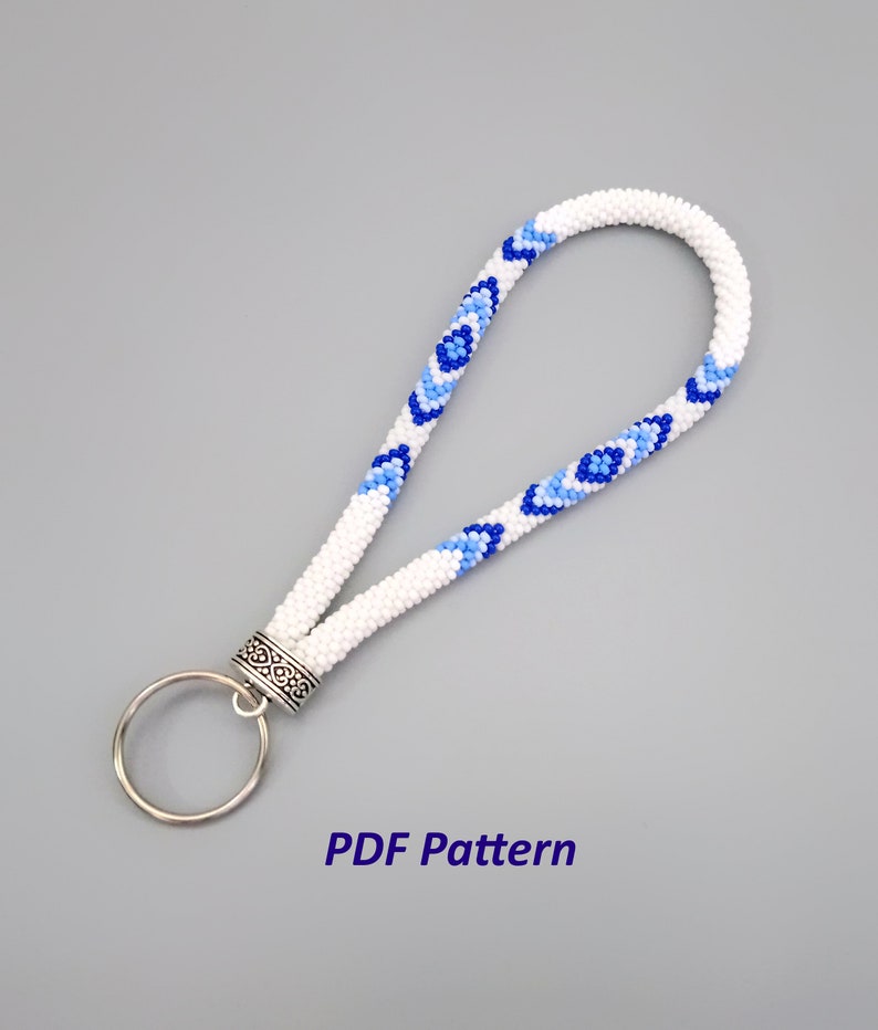 May include: White beaded key chain with blue and light blue diamond patterns and a silver key ring.  PDF Pattern.