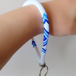 May include: White and blue beaded lanyard with a silver key ring.  PDF Pattern.