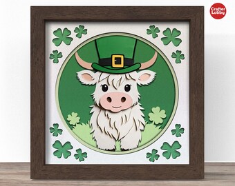 May include: A white highland cow wearing a green leprechaun hat with a gold buckle. The cow is surrounded by green shamrocks and is set against a white background.