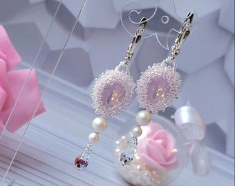 Pinky white drop earrings with Austrian crystals, stones, and silver ear wires with other accessories.