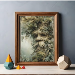 May include: A framed art print featuring a detailed illustration of a tree with a face, surrounded by foliage. The artwork is set in a wooden frame and rests on a white surface. Decorative geometric shapes in yellow, teal, and red are in the foreground.