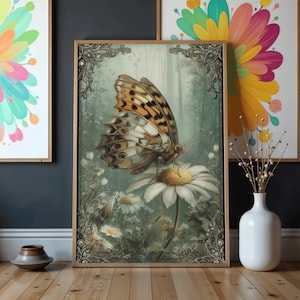 May include: A framed art print featuring a detailed illustration of a butterfly with brown and white patterned wings perched on a white daisy. The artwork has a vintage aesthetic with a soft, green background and ornate frame.