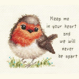 May include: Cross-stitch design featuring a robin with a red breast, brown back, and white belly, perched on green grass. The text reads "Keep me in your heart and we will never be apart". A charming, handmade piece.
