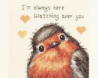 May include: Cross-stitch artwork featuring a close-up of a robin bird with a red breast, gray head, and black eyes. The text "I'm always here Watching over you" is stitched above the bird, with three small heart shapes.