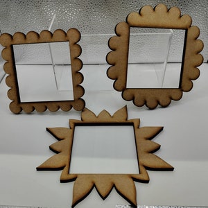 May include: Three wooden picture frames with scalloped edges. The frames are different sizes and shapes. The frames are made of natural wood and have a rustic look.