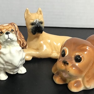 Set of three bisque ceramic dogs