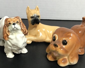 Set of three bisque ceramic dogs
