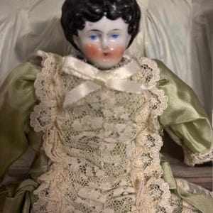 Antique 1890s China Head Doll – Original Cloth Body, Green Satin Dress, Carved Wooden Boots – 19th Century Collectible