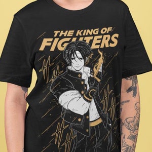 May include: Black t-shirt with a graphic print of an anime character with a fiery fist. The text "THE KING OF FIGHTERS" is printed in gold above the character.