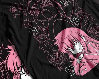 May include: Black t-shirt with a pink cartoon design featuring multiple characters with question marks and exclamation points. The characters are drawn in a simple style and have large eyes.
