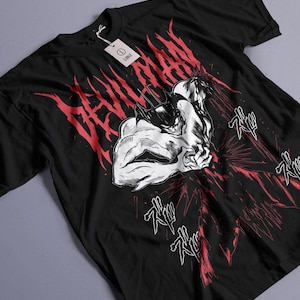 May include: Black t-shirt with a white graphic of a muscular figure with horns and the text "DEVILMAN" in red.
