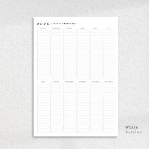 May include: A white 2026 yearly planner with a minimalist design. The planner features a clean layout with columns for each month and space for daily entries. The text "2026 Twenty Twenty Six" is at the top. The words "White Version" are at the bottom right.