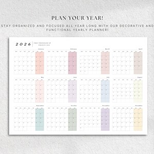 May include: A white 2026 yearly planner with a grid layout, featuring pastel-colored monthly highlights. The text "PLAN YOUR YEAR!" and "STAY ORGANIZED AND FOCUSED ALL YEAR LONG WITH OUR DECORATIVE AND FUNCTIONAL YEARLY PLANNER!" are displayed at the top.