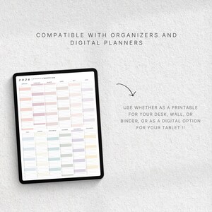 May include: A digital planner displayed on a tablet, featuring a yearly calendar layout with pastel color blocks. The text reads "Compatible with organizers and digital planners." The image also includes the text "Use whether as a printable for your desk, wall, or binder, or as a digital option for your tablet !!"
