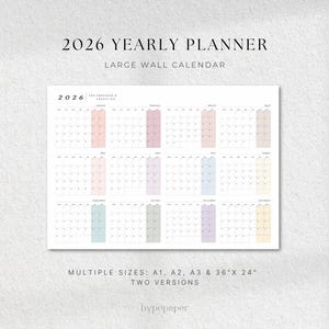 Puede incluir: Un calendario de pared anual de 2026 con un diseño minimalista. El calendario presenta un diseño de cuadrícula con cada mes mostrado. Los meses están codificados por colores en tonos pastel. El texto "2026 Yearly Planner" está en la parte superior. Hay varios tamaños disponibles.