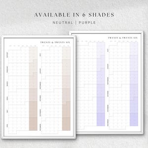 K&ouml;nnte beinhalten: Zwei gerahmte Jahresplaner, einer mit neutralen Beiget&ouml;nen und der andere mit lila Akzenten. Der Text "AVAILABLE IN 6 SHADES" und "TWENTY & TWENTY SIX" sind sichtbar. Die Planer sind minimalistisch gestaltet.