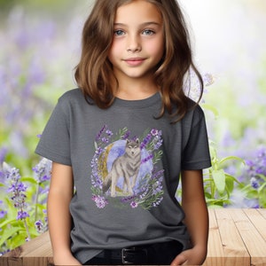 May include: A dark gray t-shirt with a watercolor design of a wolf standing in front of a crescent moon surrounded by lavender flowers.