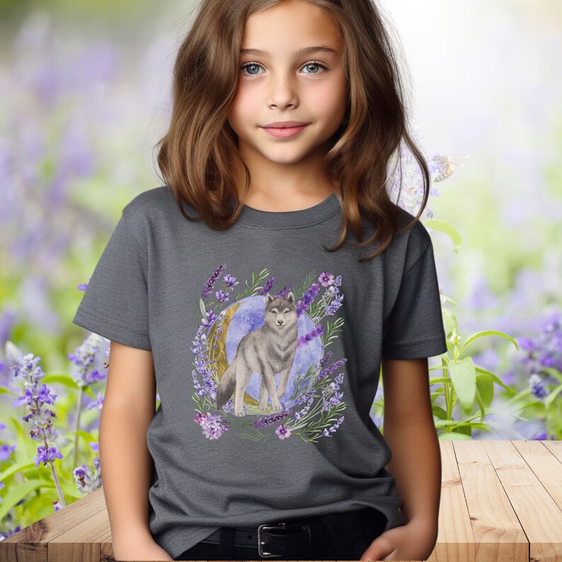 May include: A dark gray t-shirt with a watercolor design of a wolf standing in front of a crescent moon surrounded by lavender flowers.