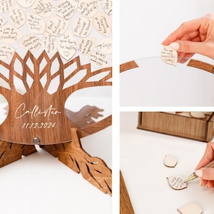 May include: A wooden tree-shaped guest book with a clear acrylic panel to hold personalized wooden leaves. The leaves are blank and can be written on by guests. The base of the tree is engraved with the date "11.12.2024" and the name "Callister".