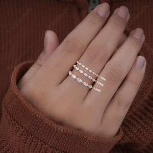 May include: Three gold rings with marquise-shaped diamonds. The rings are stacked on top of each other, with the smallest ring on top and the largest ring on the bottom. The rings are labeled with their sizes: 1.5mm, 2.0mm, and 2.5mm.
