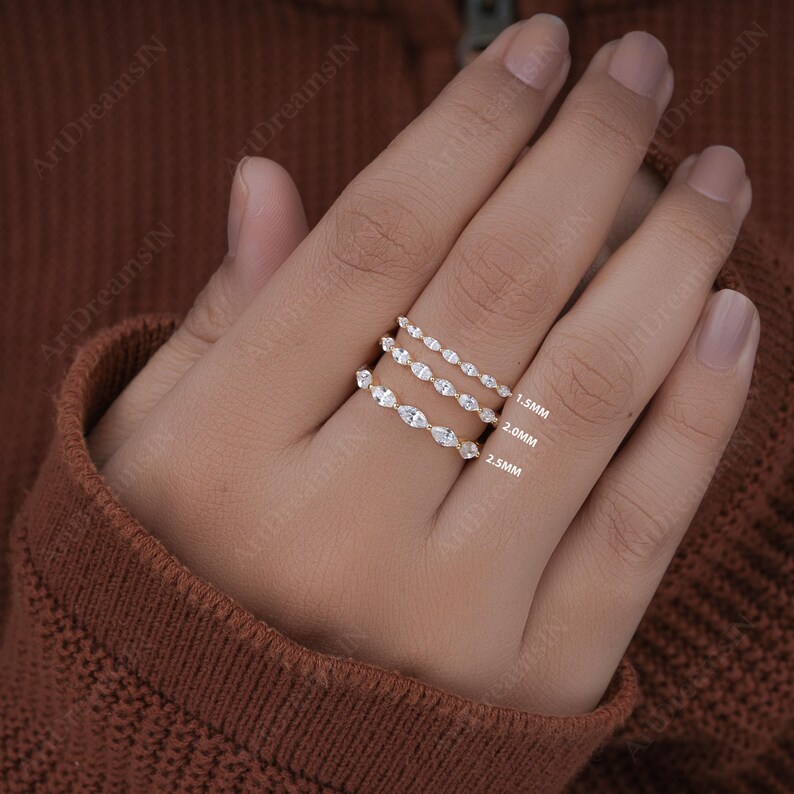 May include: Three gold rings with marquise-shaped diamonds. The rings are stacked on top of each other, with the smallest ring on top and the largest ring on the bottom. The rings are labeled with their sizes: 1.5mm, 2.0mm, and 2.5mm.
