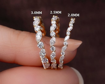 May include: Three gold rings with white gemstones, each with a different size. The rings are labeled 3.0mm, 2.5mm, and 2.0mm. The gemstones are marquise and round cut, set in a delicate band.