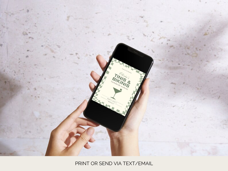 May include: A smartphone displaying a digital invitation for a party. The invitation is white with green text and a green martini glass icon. The text reads "Olivia's Tinis & Bikinis Backyard Bash!"
