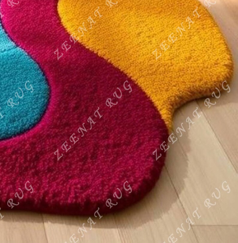 May include: A colorful, abstract rug with a wavy design. The rug is made of a soft, plush material and features shades of blue, red, and yellow.