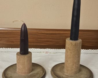 Vintage pair of wooden industrial spools or bobbins repurposed as candle holders. Candles included.