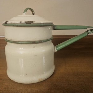 Vintage cream and green enamelware double boiler pot.