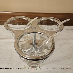 Vintage Mid-century Kromex chrome and glass three-part condiment server with spoons.