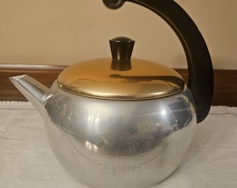 Vintage Ware-Ever aluminum teapot with a gold lid and bakelite handle.