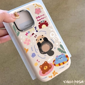 May include: A beige phone case with a colorful summer-themed design. The case features illustrations of an otter, crab, bear, and cat in a pool, along with the text "Happy Summer".