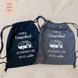 May include: Two drawstring backpacks, one black and one gray, with white text and a camper graphic. The text reads "ICH BIN EIN Camperkind" and "WIE EIN NORMALES KIND NUR VIEL cooler."
