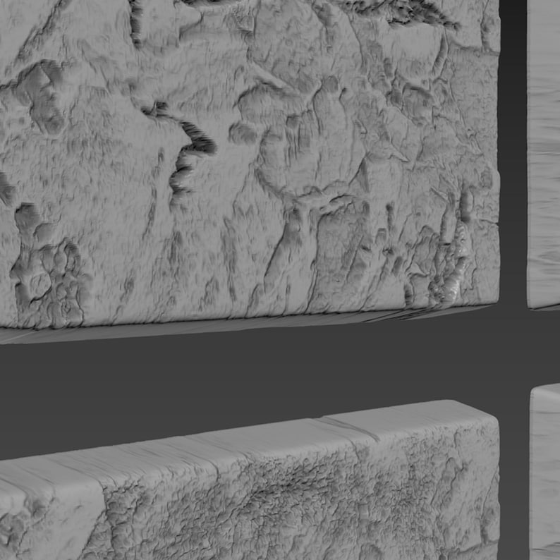 May include: A close-up of a gray, textured, rectangular surface. The surface has a rough, uneven texture, resembling stone or concrete.